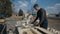 Teenager carpenter worker wear a uniform and using wood cutting machine. Wide view.