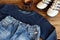 Teenager casual outfit. Boys shoes, clothing and accessories on wooden background - sweater, trousers, sneakers. Top view. Flat