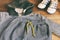 Teenager casual outfit. Boys shoes, clothing and accessories on wooden background - sweater, trousers, sneakers. Top view. Flat