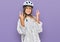 Teenager caucasian girl wearing bike helmet shouting with crazy expression doing rock symbol with hands up