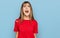 Teenager caucasian girl wearing casual red t shirt angry and mad screaming frustrated and furious, shouting with anger