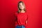 Teenager caucasian girl wearing casual red t shirt with a happy and cool smile on face