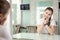 Teenager Caucasian young girl is preparing for audition in front of mirror in dressing room