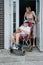 teenager with Cerebral Palsy in special chair going for a walk with mother