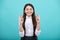 Teenager child holding fingers crossed for good luck. Portrait of cheerful girl prays and hopes dreams come true