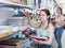 Teenager choosing copybook in stationery store