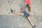 Teenager climbing a rock wall