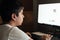 Teenager concentrated is studying at home attending online classes during the coronavirus COVID-19 pandemic quarantine