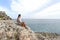 Teenager couple looking at horizon on a cliff