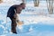 A teenager digging a snow shovel wooden.