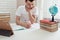 Teenager does homework at the table in his room