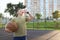 A teenager drinks water on a basketball court. Healthy lifestyle and sport concepts