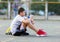 Teenager drinks water from a bottle after the game.