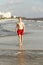 Teenager enjoys jogging along the beach