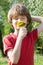 Teenager enjoys odors from dandelions