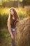 Teenager farmer girl with haystack close up photo