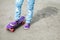 Teenager feet in jeans and gumshoes with skateboard