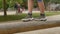 Teenager feet tread wooden log forest school. He trains vestibular apparatus.