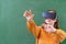 Teenager female student wearing virtual reality glasses in classroom at school. Innovative teaching methods.