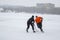 Teenager fighting with dad for the pack while playing hockey on a frozen river Dnipro in Ukraine