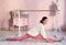 Teenager girl in ballet class hall exercise split