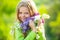 Teenager girl with bouquet of lilac. Funny teenager girl having fun outdoors. Spring blossom.