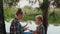 Teenager girl and boy playing rock paper scissors on river shore in pine woodland. Happy sister and brother playing rock