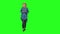 Teenager girl calmly walking in big red headphones, chooses music on the mobile phone on green screen. Front view.