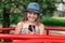 Teenager girl communicates in a park on a carousel. Smiling teenager with phone