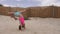 Teenager girl doing acrobatic stunt on sand empty beach. Slow motion.