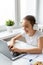 Teenager girl doing homework at home in front of a laptop monitor. Vertical photo.