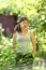 Teenager girl farmer gardening in farm yard on seed bed