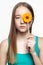 Teenager girl with with flower lollipop in hands closing eye