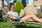 Teenager girl in glasses reading book, resting on sunbed standing in backyard