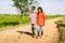 Teenager girl helping to blind brother by walking each other at mountain - concept of caregiver,friendship bonding and