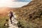 Teenager girl on a hike in a mountains. The model walks on a stone walk path. Letterfrack, Connemara National Park, county Galway