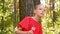 Teenager girl holding in hand white dandelion in summer park. Young girl looking around in green park. Portrait girl