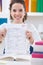 Teenager girl holding test paper with result
