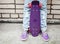 Teenager girl in jeans holds a skateboard