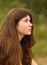 Teenager girl with long thick brown hair outdoor portrait