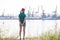 Teenager girl looking at port cranes