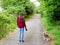 Teenager girl in a park with her yorkshire terrier on a leash