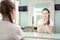 Teenager girl is preparing for casting in front of the mirror in the dressing room