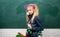 Teenager girl at school on the blackboard.