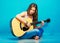 Teenager girl singer with guitar