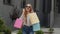 Teenager girl in trendy clothes with multicolor shopping bags. Black Friday sale discounts concept