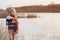 teenager girl with tulip on background spring river