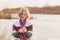 teenager girl with tulip on background spring river