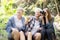 Teenager girl and two grandmother traveling travel to forest and adventure while using binoculars exploration together.