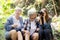 Teenager girl and two grandmother traveling travel to forest and adventure while using binoculars exploration together.